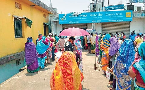 Jan Dhan account holders outside Canara Bank branch at Choudwar on Friday. (Photo | EPS)