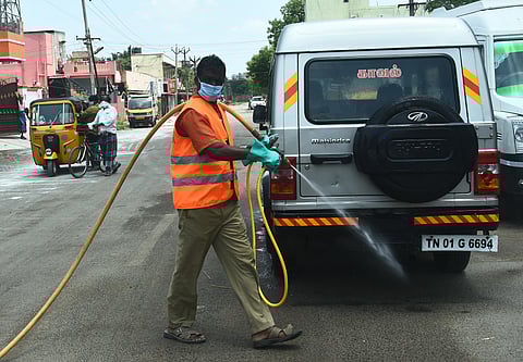 Greater Chennai Corporation workers disinfecting a street in the city (Photo | Ashwin Prasath, EPS)