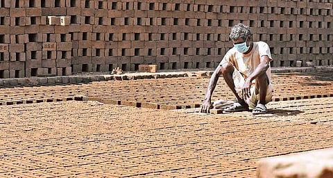 A brick worker wears a mask to avoid infection. (Photo | Madhav K, EPS)
