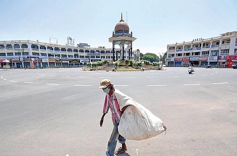 A ragpicker walks near a deserted KR Circle in Mysuru on Friday | UDAYSHANKAR S