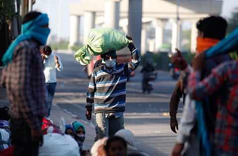 Migrant workers at Anand Vihar in New Delhi during a nationwide lockdown on Sunday in the wake of coronavirus. (Photo | Anil Shakya, EPS)