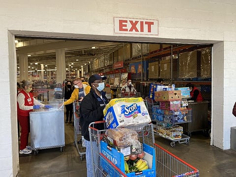 Shoppers wear masks as they get supplies at a Costco on April 18, 2020, in Arlington, Virginia. (Photo | AFP)