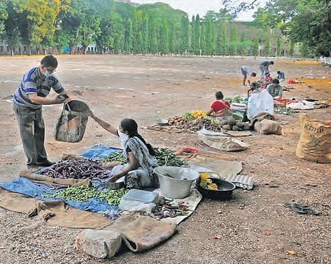 A customer purchasing vegetables at a mini-rythu bazar set up at Andhra Loyola College grounds in Vijayawada on Saturday. (Photo | EPS/Prasant Madugula)