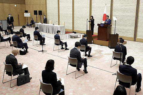 Shinzo Abe, Japan's prime minister, top right, speaks during a news conference at the prime minister's official residence in Tokyo. (Photo | AP)