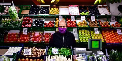 A man at his fruit market stall in Pamplona, northern Spain. (Photo | AP)