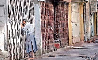A boy takes a peek into an empty mosque which was closed due to the lockdown, at Avenue Rd in Bengaluru on Wednesday | Nagaraja Gadekal