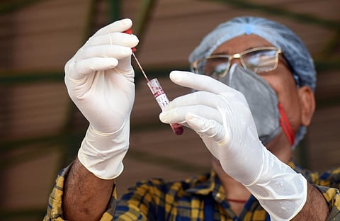 A medic works on a sample for COVID-19 rapid test center in Bhubaneswar. (Photo | Biswanath Swain, EPS)