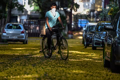 A man wearing a face mask rides a bicycle during the nationwide lockdown imposed in the wake of coronavirus pandemic in Mumbai Sunday April 19 2020. (Photo | PTI)