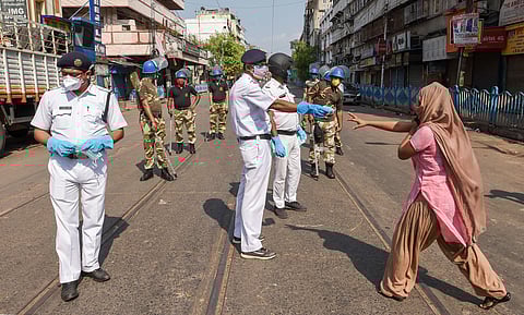Security personnel stop a woman while patrolling at Mechua during a nationwide lockdown imposed in the wake of coronavirus pandemic in Kolkata Sunday April 19 2020. (Photo | PTI)