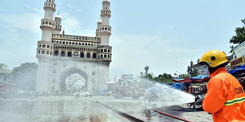 Disinfectant is sprinkled to prevent the spread of COVID-19 by Telangana State Disaster Response and Fire Services Department at Hyderabad's Charminar during lockdown. (Photo| EPS)