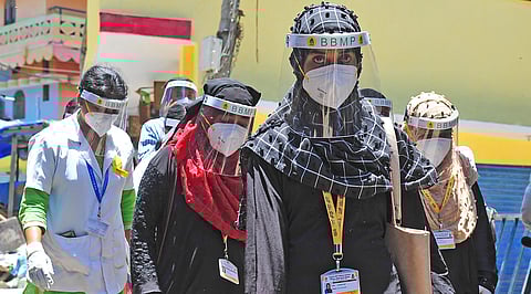 BBMP health workers go around Padarayanapura in Bengaluru on Monday, a day after the area witnessed violence | Pandarinath B