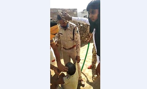 The injured cop being helped by the villagers (Photo |