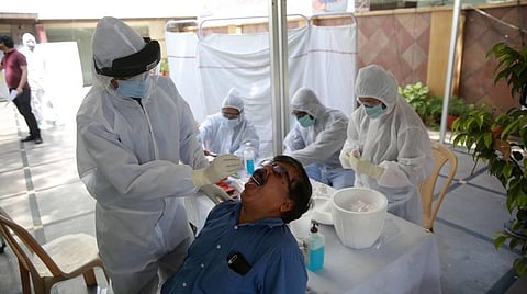 A doctor takes a swab sample of a journalist at a COVID-19 coronavirus testing camp . (Photo | Shekhar Yadav, EPS)