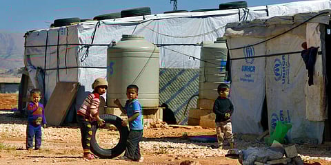 Children play outside their family tents at a refugee camp in Lebanon. (Photo | AP)