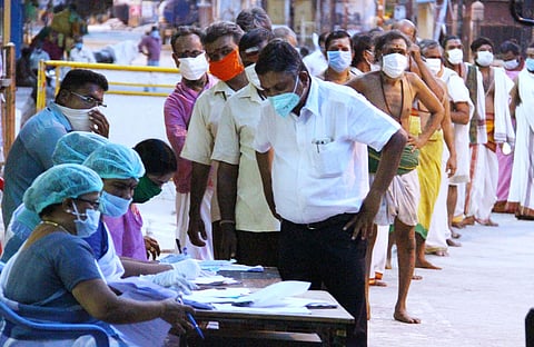 Officials from health department taking samples from Meenakshi Amman Temple employees in Madurai. (Photo| EPS/ KK SUNDAR)