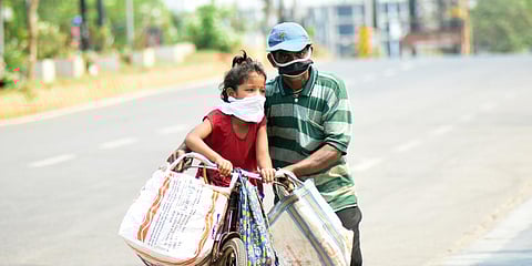 A man and his daughter on the way to home with grocery during lockdown in Bhubaneswar. (photo| Biswanath Swain, EPS)