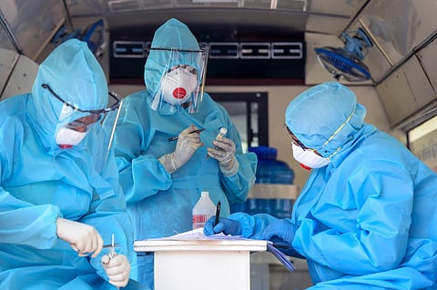 Health workers work on samples of swab test of police personnel inside a COVID-19 testing mobile van during the nationwide lockdown to curb the spread of coronavirus in Chennai Wednesday April 22 2020. (Photo | PTI)