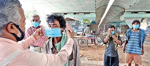 A volunteer distributing masks among people in Bhubaneswar | Express