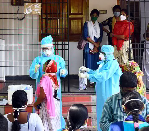 Health department staff collecting samples from asha workers and grama volunteers because of Covid-19 at grama sachivalayam MVP colony in Visakhapatnam on Thursday. (Photo | EPS/Satyanarayana)