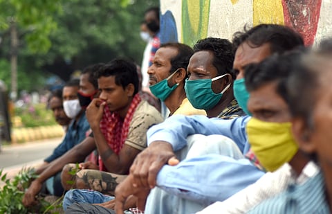 Daily wage labourers waiting for work at Delta Square during lockdown in Bhubaneswar on Thursday. (Photo | EPS/Biswanath Swain)