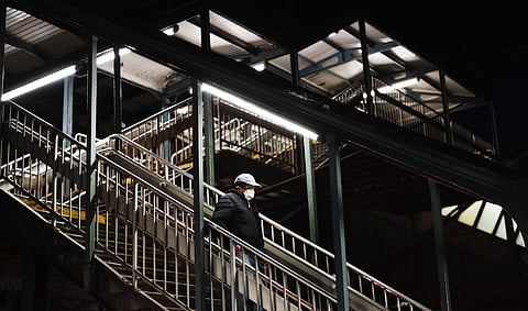 A man walks down the stairs in a quiet 61st Street–Woodside subway station in the Queens borough of New York, Thursday night, April 23, 2020, during the coronavirus pandemic. (Photo | AP)