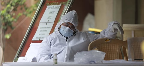 Health workers take a nap after their continuous duty of collect swab samples from people for COVID -19 tests in New Delhi. (Photo | Shekhar Yadav, EPS)