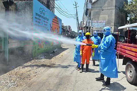 Municipality workers spray disinfectant at a locality during a nationwide lockdown to curb the spread of coronavirus in Moradabad Wednesday April 22 2020. (Photo | PTI)