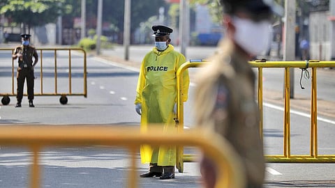 Sri Lankan police officers stand guard at a check point during a curfew imposed to stop spreading of a new virus in Colombo, Sri Lanka, Sunday, April 12, 2020. (Photo | AP)