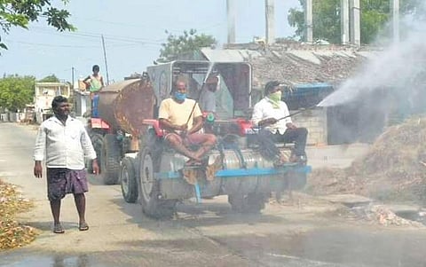 People spraying sodium hypochlorite at Chagallu village in Nekarikallu mandal of  Guntur district on Friday I Express