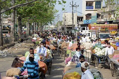 Vendors selling vegetbales wait to obtain a pass to enter a market during the nationwide lockdown to curb the spread of coronavirus in Jalandhar Saturday April 25 2020. (Photo | PTI)