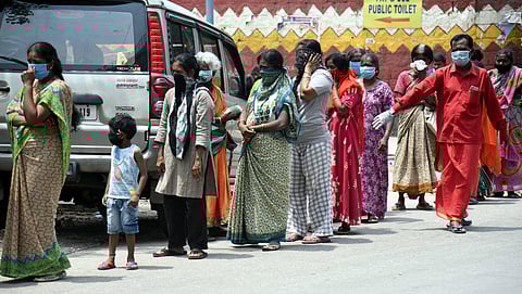 People wait in queue to collect ration in Bengaluru on Friday. (Photo | Nagaraja Gadekal, EPS)