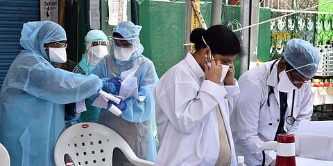 Health workers wearing PPEs wait for the visit of COVID-19 Central team at containment zone area at Fakheer Galli Old Malakpet, in Hyderabad. (photo| ANI)