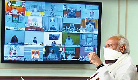 PM Narendra Modi wearing a protective mask chairs a video meeting with CMs on COVID-19. (Photo | PTI)