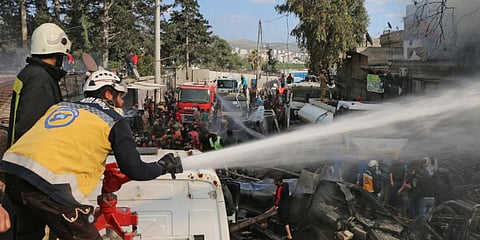 Syrian Civil Defence rescue workers, also known as White Helmets, at the scene of a fuel truck bomb which killed 36 people in north Syria's Afrin. (Photo| AFP)