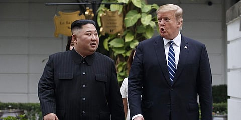 President Donald Trump and North Korean leader Kim Jong Un take a walk after their first meeting. (File photo| AP)