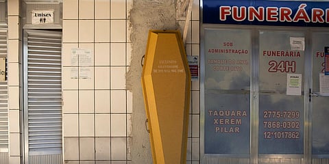 An empty coffin stands against the wall at the entrance of a funeral home during the COVID-19 pandemic at the Nossa Senhora das Gracas cemetery in Duque de Caxias, Rio de Janeiro, Brazil, Monday, April 27, 2020. (Photo | AP)