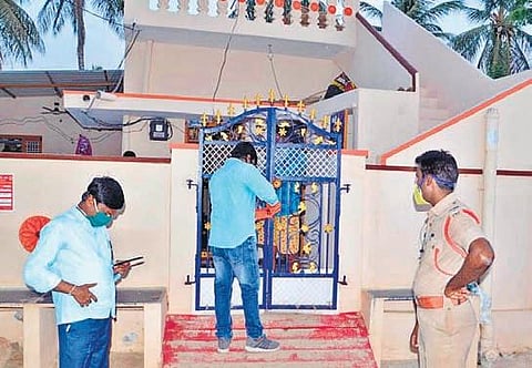 Officials locking a house in a red zone in Gadwal town on Monday | EXPRESS