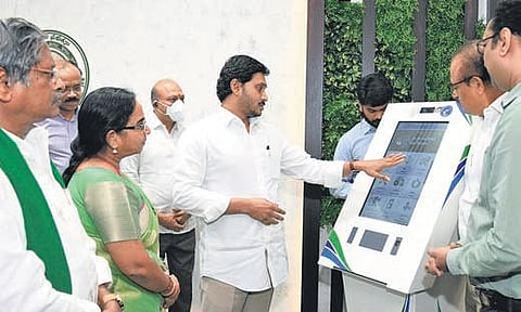 Chief Minister YS Jagan Mohan Reddy takes a look at a kiosk during a review meet on Rythu Bharosa at his camp office in Tadepalli on Monday | Express