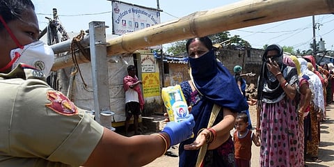 Sanitary napkins being distributed by Commisionrate Police at containment zone of Surya Nagar in Bhubaneswar. (File Photo | Biswanath Swain, EPS)