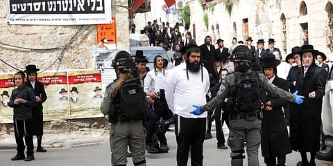 Ultra Orthodox Jews gather during a protest against government's measures to stop the spread of the coronavirus in the orthodox neighborhood of Mea Shearim in Jerusalem. (Photo | AP)
