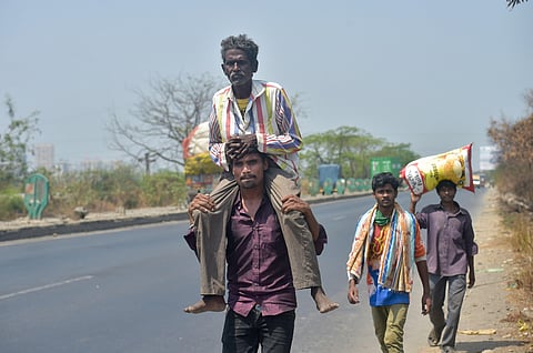 Migrant workers from Akola district of Maharashtra walk along Mumbai-Nashik highway to reach their native places during a nationwide lockdown in the wake of coronavirus in Thane Wednesday April 29 2020. (Photo | PTI)