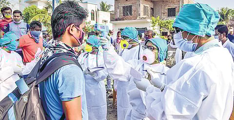 A health worker checks the temperature of a migrant labour in West Bengal’s Nadia on Wednesday | Pti