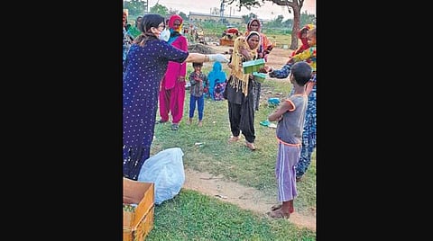 Dr Susmita Dash distributing formula milk powder to women (Photo | EPS)