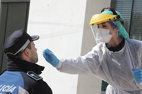 A handout picture released by the Madrid City Hall shows a health worker handling a swab to test a municipal police officer for the COVID-19 coronavirus in Madrid. This image is used for representational purposes. (Photo | AFP)