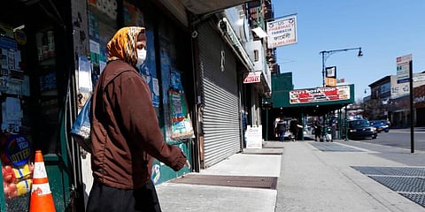 A Bangladeshi woman wearing protective face mask leaves after shopping at a grocery store. (Photo | AP)