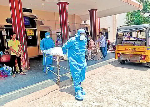 The body of a 65-year-old man being shifted to mortuary in Kakinada on  Saturday (Photo | EPS)