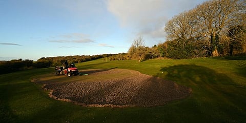 Greenkeepers collect the cores from a green, after the process of Hollow Tining which helps to aerate the soil, as they work to maintain the course at Dyke Golf Club, north of Brighton, in southern England. (File photo| AFP)
