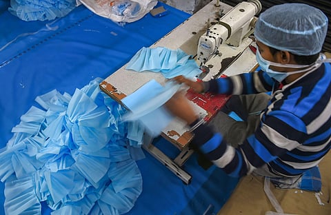 A worker stitches face masks during a nationwide lockdown in the wake of coronavirus pandemic at a private manufacturing unit on the outskirts of Srinagar Monday April 6 2020. (Photo | PTI)