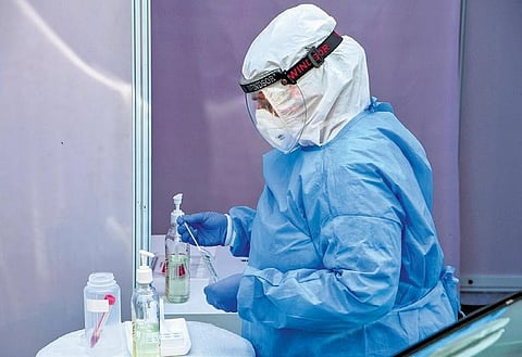 A technician of Dr Dangs Lab demonstrates before the media a sample collection process for COVID-19 tests in New Delhi. (File Photo | PTI)