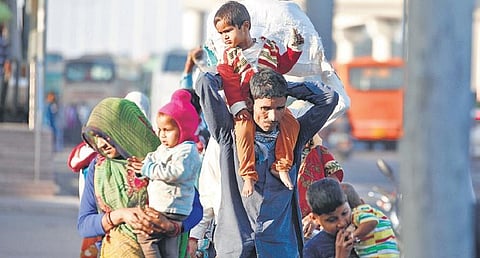 Migrants on their way home at a bus terminal in New Delhi | File